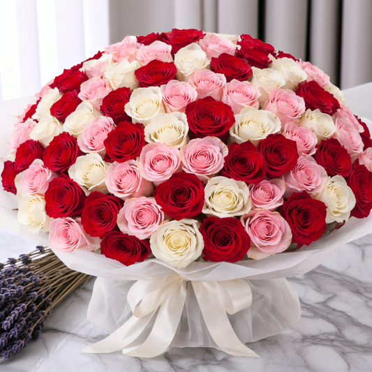 Bouquet of red, pink, and white roses on a marble surface with lavender.