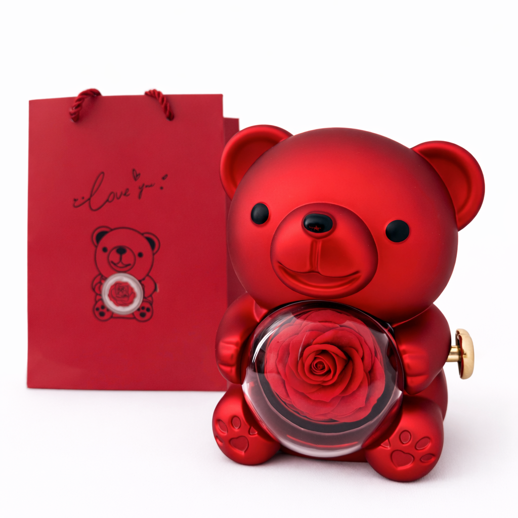 Red teddy bear-shaped perfume bottle with a rose and a matching red gift bag on a white background