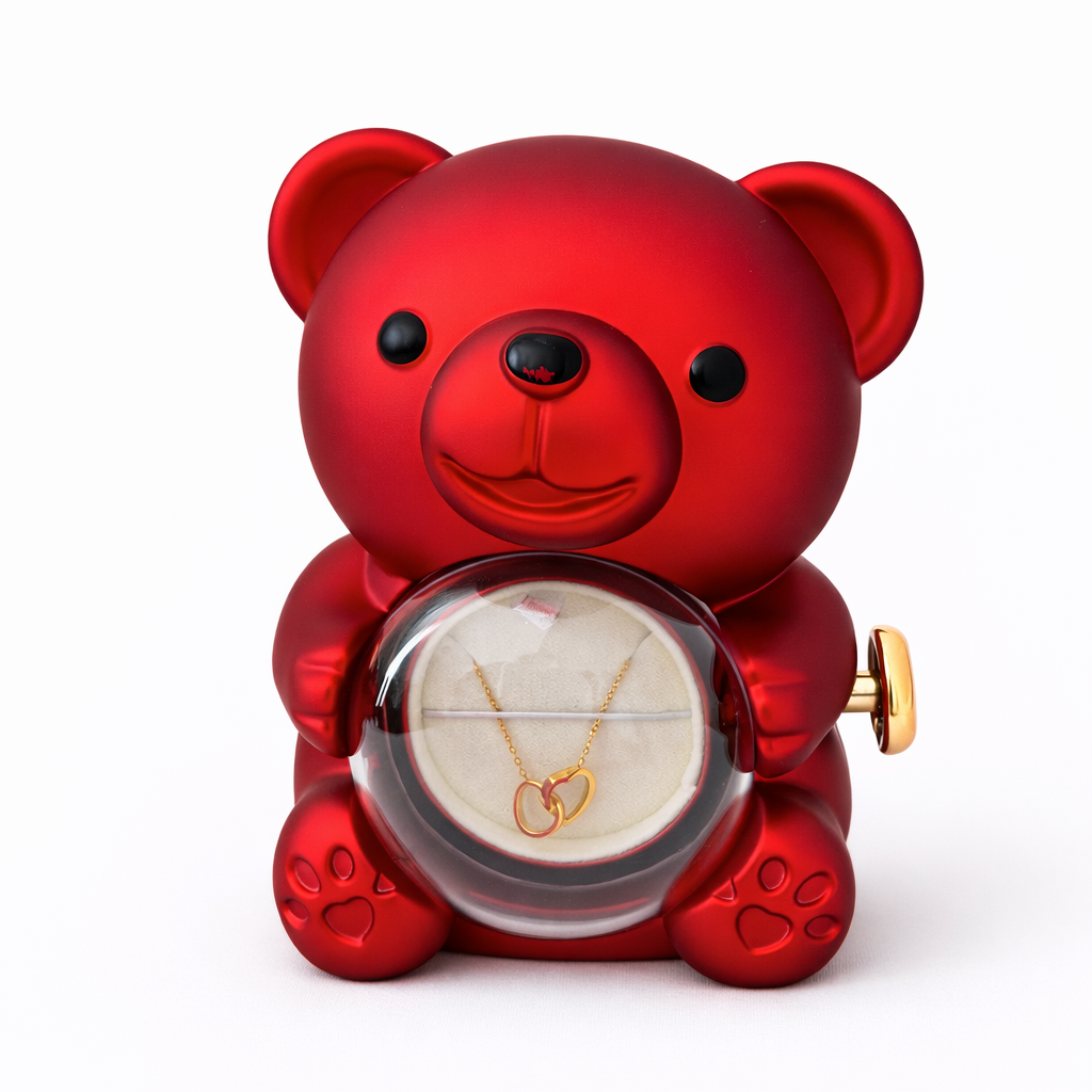 Red teddy bear-shaped jewelry box with a necklace inside on a white background