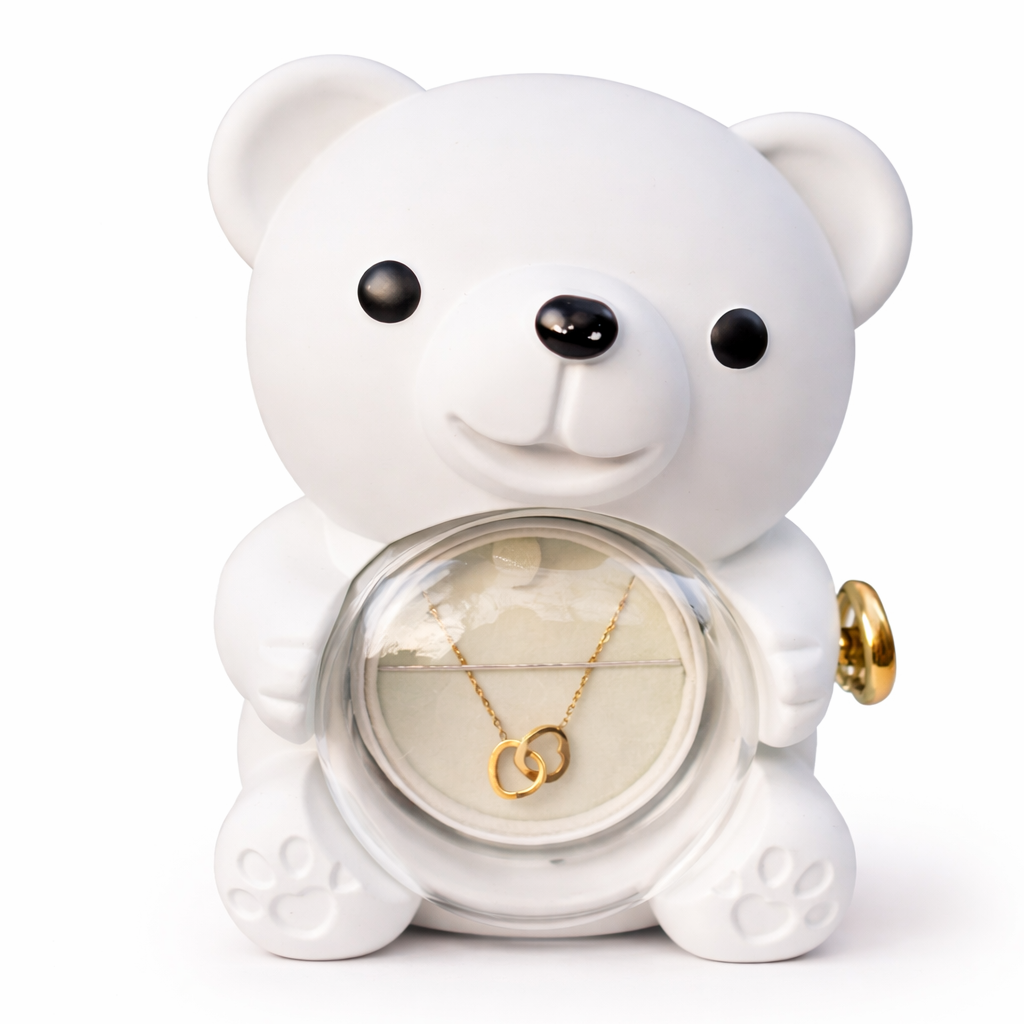 White ceramic bear figurine with a necklace inside on a white background