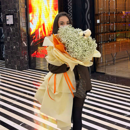 Woman holding a bouquet of flowers in a store setting