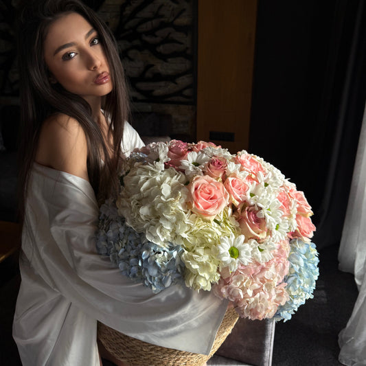 Woman holding a bouquet of flowers indoors
