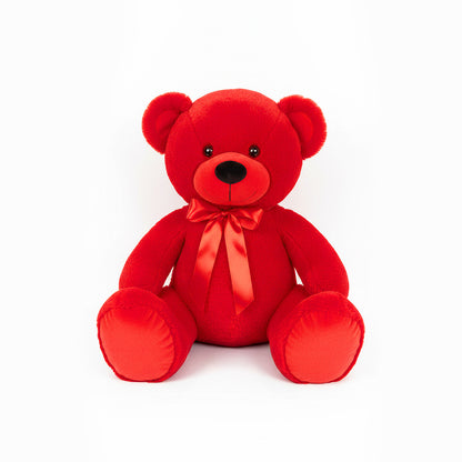 Red teddy bear with a bow tie on a white background